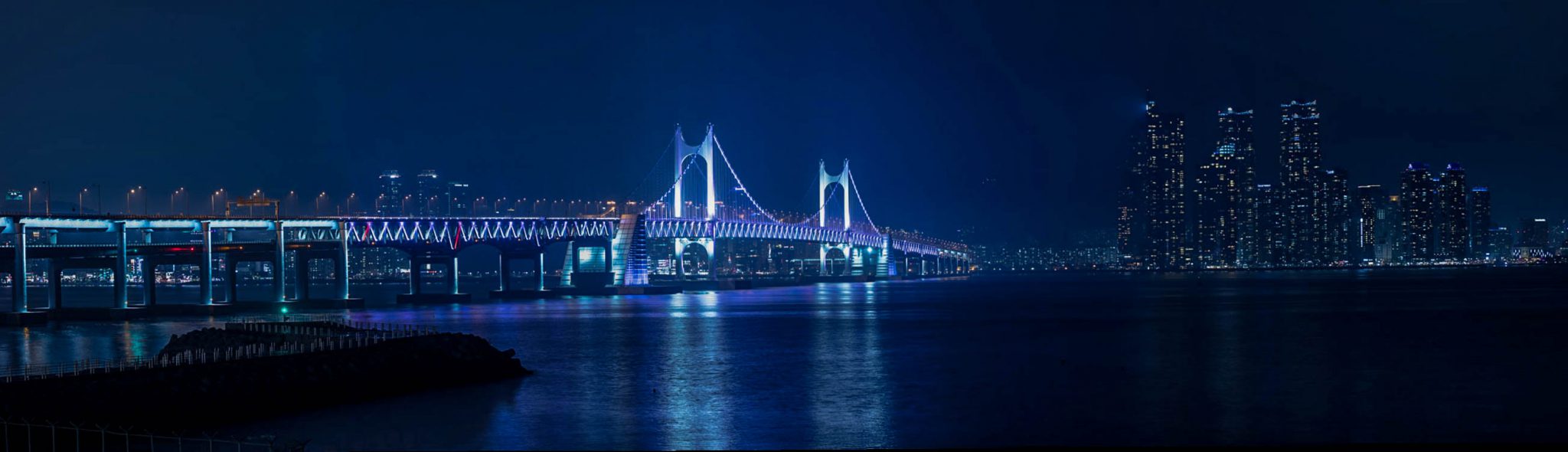Brightly lit bridge at night time in Busan, South Korea.